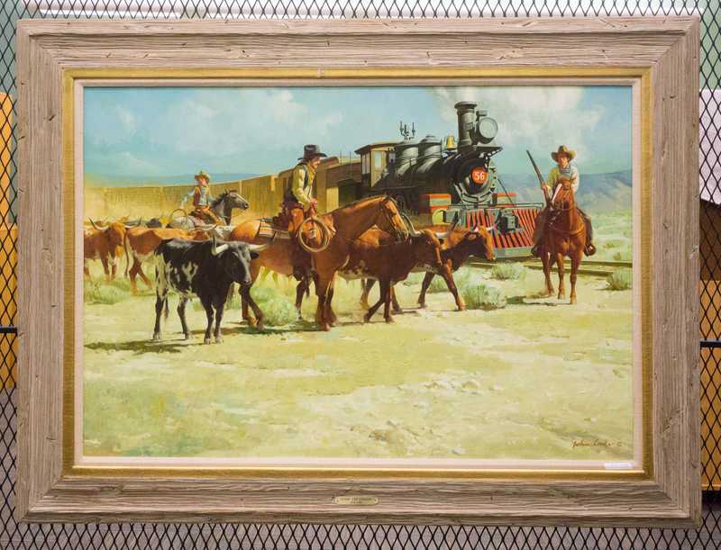 Depicts cowboys loading cattle o