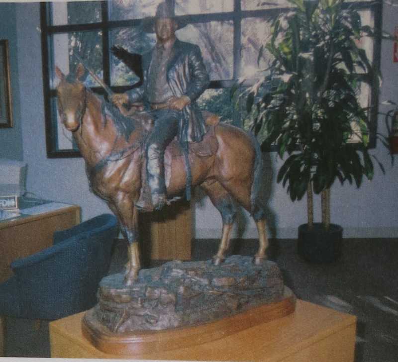 Depicts John Wayne on horseback