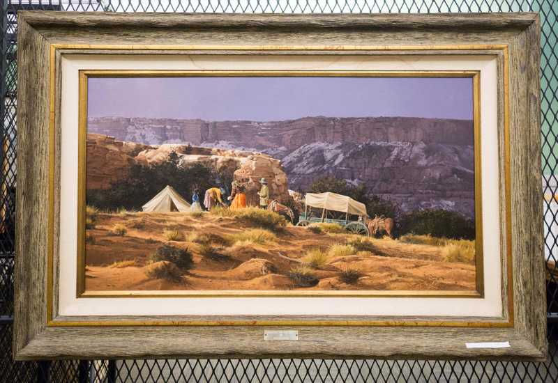Depicts covered wagon, American