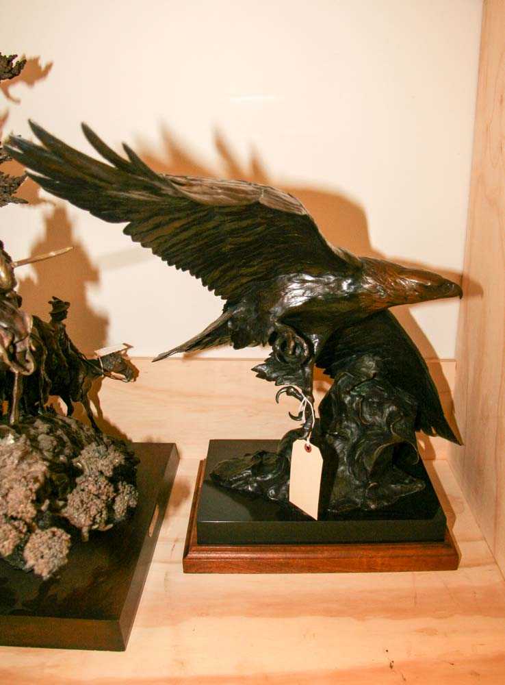 This bronze sculpture depicts a